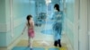 Russia -- A woman carries a dropper of her daughter, patient of the oncology unit, in the RDKB (a cyrillic acronym for Russian Children's Clinical Hospital) in Moscow, November 10, 2011 